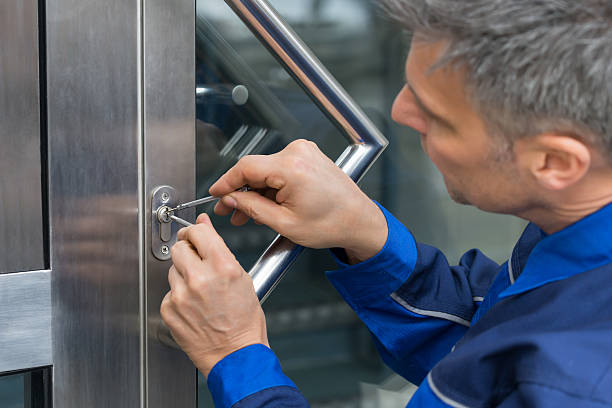 Male Man lockpicker fixing door handle at home