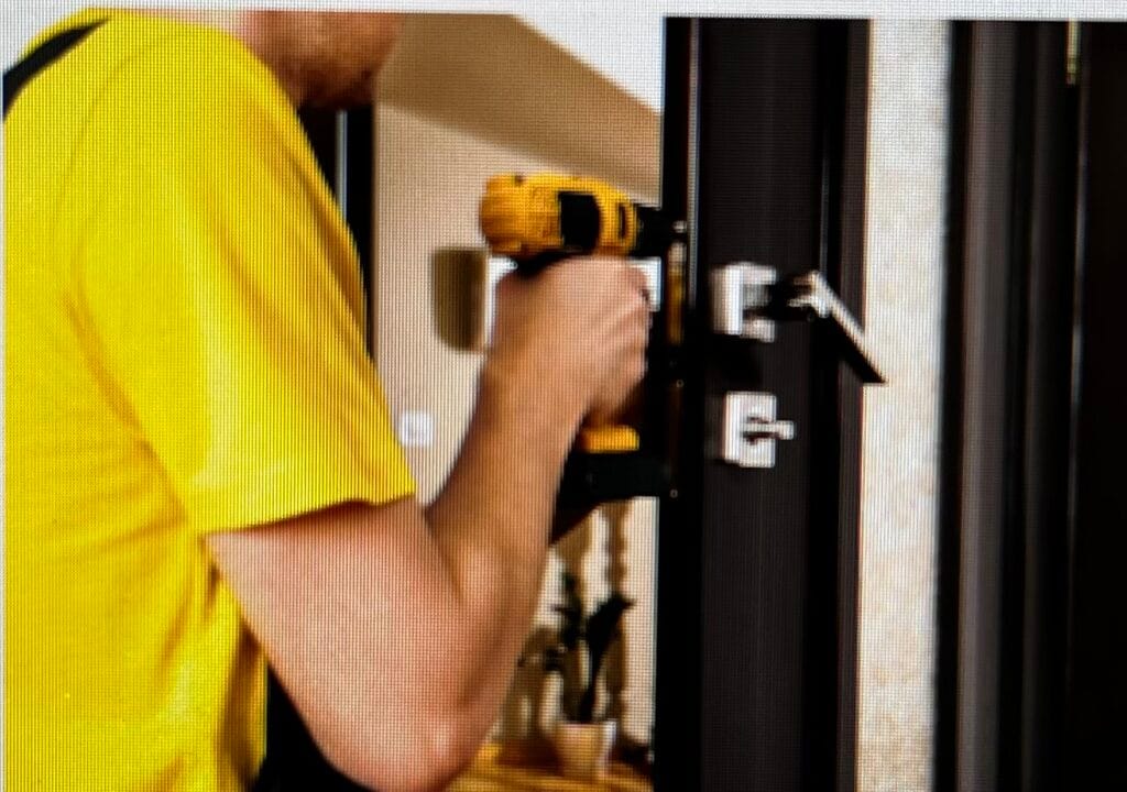 Locksmith working on door