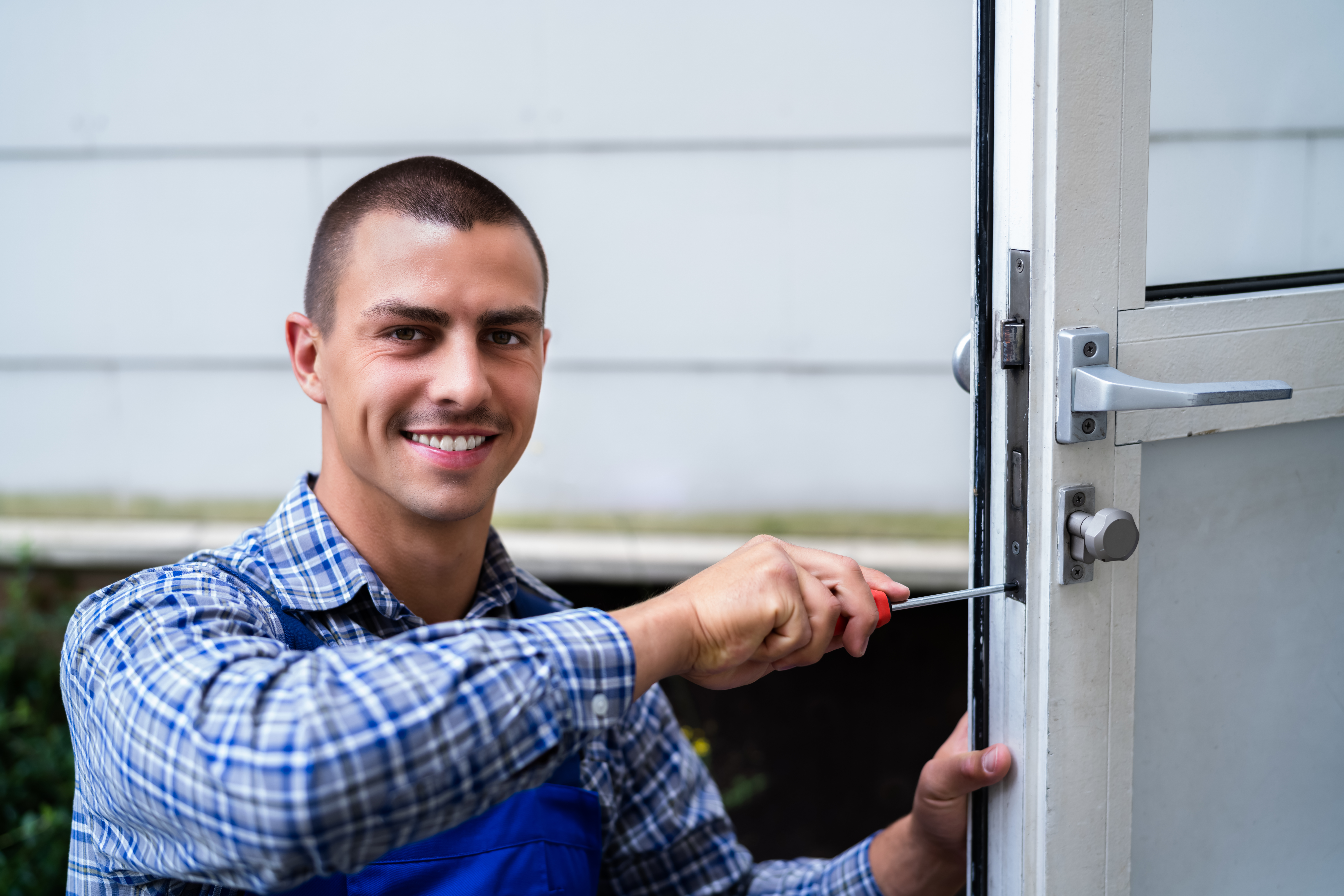 Locksmith Repairing a Lock on Door