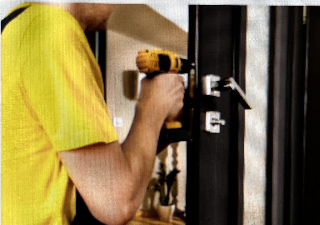Shows locksmith opening a door
