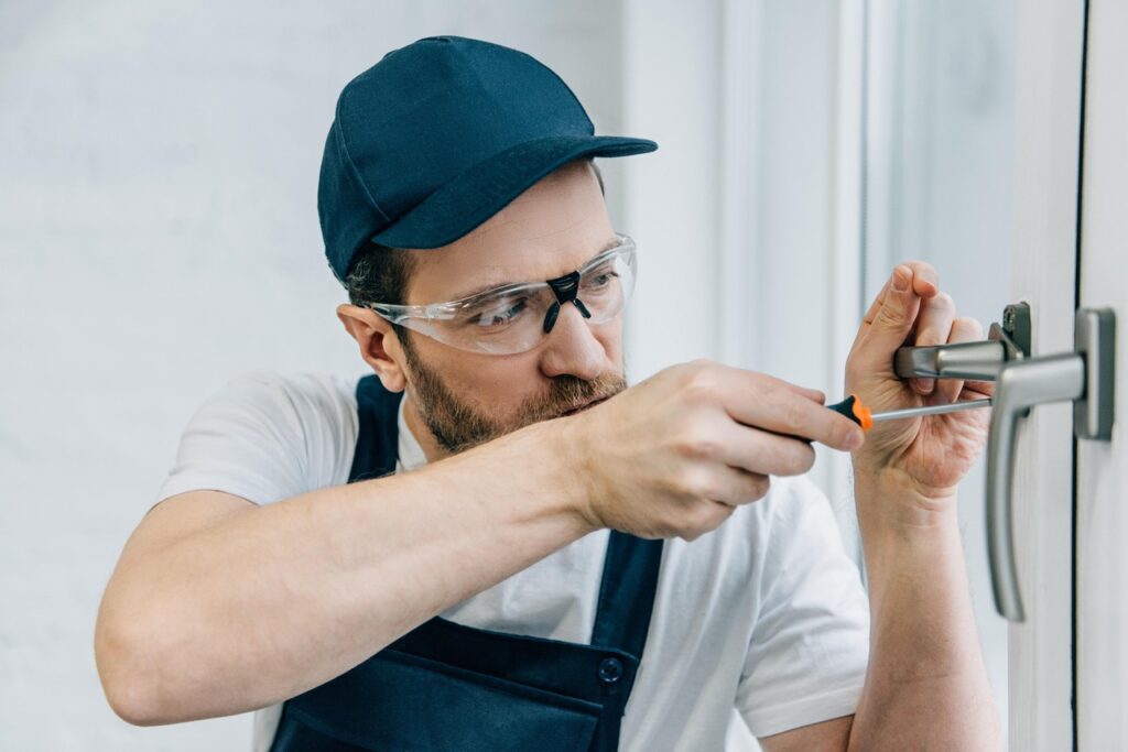 Locksmith working on door